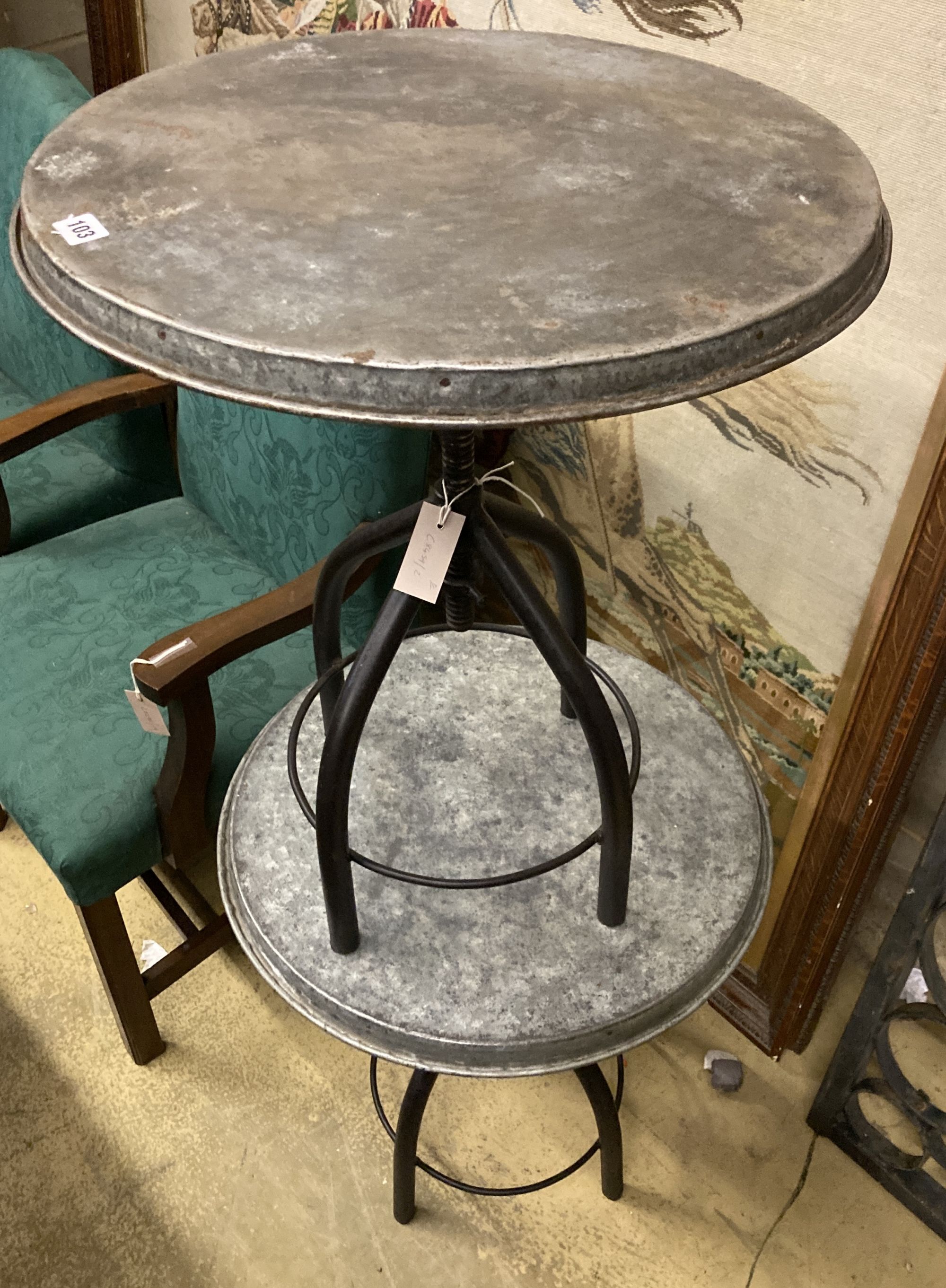 A pair of industrial style circular metal and wrought iron occasional tables, 54cm diameter, height 65cm